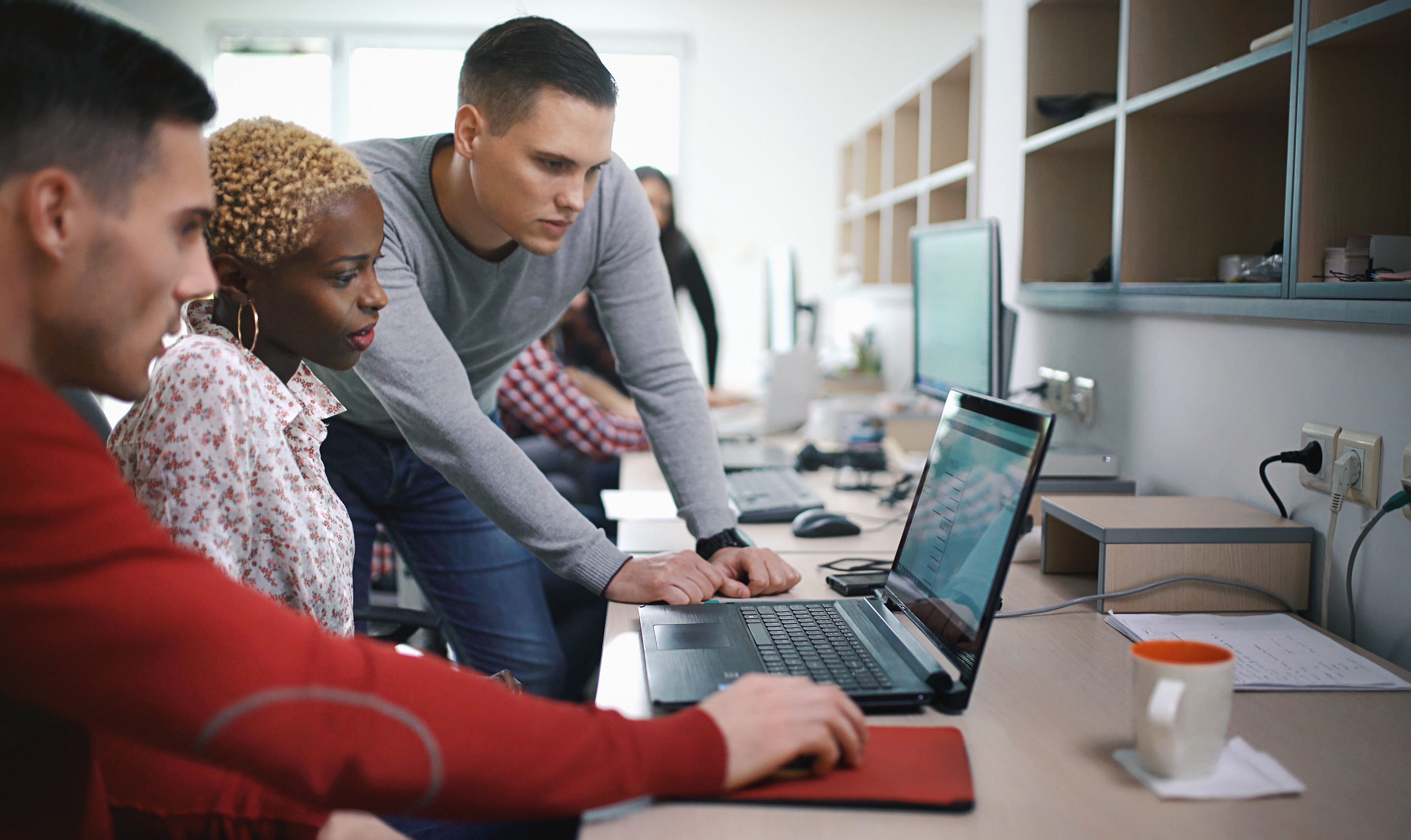 Team reviewing computer screen - JConnelly Blog - 8 Takeaways from Jack Dorsey's Talk on Cryptos, Diversity and the Mobile Workforce